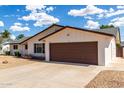 Charming single-story home with a two-car garage and desert landscaping on a sunny day at 1203 E Bishop Dr, Tempe, AZ 85282