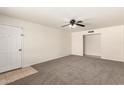 Spacious living room featuring neutral carpet and a ceiling fan at 1203 E Bishop Dr, Tempe, AZ 85282