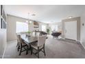 Open-concept living and dining area with neutral tones and abundant natural light at 12513 W Dreyfus Dr, El Mirage, AZ 85335