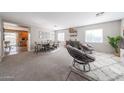 Bright, spacious living area with carpet floors and stylish decor at 12513 W Dreyfus Dr, El Mirage, AZ 85335