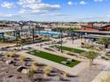 Community park and recreation area including pool, playground, and covered seating with mountain views at 131 N 175Th Ln, Goodyear, AZ 85338