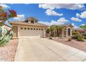 A charming home featuring a two-car garage, desert landscaping, and a covered entrance, enhancing its curb appeal at 16083 W Cambridge Ave, Goodyear, AZ 85395