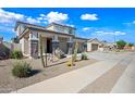 Attractive two-story residence displaying a two-car garage, desert landscaping, and a welcoming covered porch at 16840 W Monroe St, Goodyear, AZ 85338