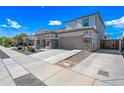 Charming two-story house showcasing a two-car garage, desert landscaping, and a quaint covered porch at 16840 W Monroe St, Goodyear, AZ 85338