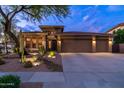 Charming home exterior with desert landscaping, three-car garage, and appealing architectural features at 2038 W Whisper Rock Trl, Phoenix, AZ 85085