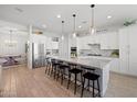 Bright, open kitchen with stainless steel appliances and large island for barstool seating at 22728 E Camacho Rd, Queen Creek, AZ 85142