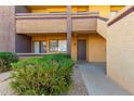 Exterior shot of condo showing door with small bushes, rock and walkway at 3601 W Tierra Buena Ln # 168, Phoenix, AZ 85053