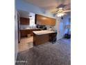 Functional kitchen features wood cabinets, breakfast bar and ample counter space, offering both style and convenience at 3749 E Laurel Ln, Phoenix, AZ 85028