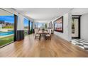 Spacious dining room with hardwood floors, modern art, and large windows overlooking the pool and mountains at 4218 E Palo Verde Dr, Phoenix, AZ 85018
