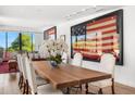 Refined dining area featuring a wooden table, upholstered chairs, and curated wall art at 4218 E Palo Verde Dr, Phoenix, AZ 85018