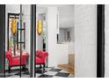Elegant foyer with black and white marble flooring, red accents and a view of a bright, modern interior at 4218 E Palo Verde Dr, Phoenix, AZ 85018
