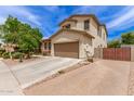Two-story home featuring a two-car garage and brick paver accents with a blue sky at 42711 N 45Th Dr, Phoenix, AZ 85087