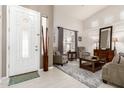 Bright living room featuring a decorative front door and neutral tones throughout the room at 42711 N 45Th Dr, Phoenix, AZ 85087