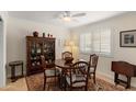 Traditional dining room with a round table, wood chairs, shuttered window, and a classic china cabinet at 4306 E Dragoon Cir, Mesa, AZ 85206