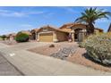 A lovely home exterior with a desert landscape, a tan exterior, and an attached garage at 4434 E Thistle Landing Dr, Phoenix, AZ 85044