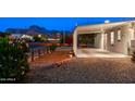 Home exterior with gravel yard, covered parking, desert landscaping and mountain views at 466 N Rennick Dr, Apache Junction, AZ 85120