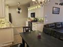 Stylish kitchen and dining area, featuring granite countertops, a breakfast bar, and stainless steel appliances at 4721 E Abraham Ln, Phoenix, AZ 85050