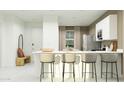 Open-concept kitchen features white cabinets, stainless steel appliances, a large island, and modern design at 4748 E Amethyst Ln, San Tan Valley, AZ 85143