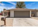 A single-story home with a two-car garage sits beneath a blue sky at 4832 W Golden Ln, Glendale, AZ 85302