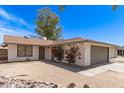 This single-story home features desert landscaping and mature flowering bushes at 4832 W Golden Ln, Glendale, AZ 85302