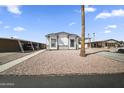 Close up of the exterior of a home with two carports and desert landscaping at 500 N 67Th Ave # 52, Phoenix, AZ 85043