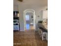 Hallway with light brown ceramic tile floor and archway into the living area at 546 E San Carlos Way, Chandler, AZ 85249
