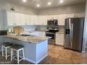 Well-lit kitchen featuring white cabinets, stainless steel appliances, and granite countertops at 546 E San Carlos Way, Chandler, AZ 85249