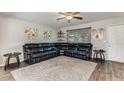Spacious living room with wood floors, ceiling fan, and a comfortable sectional sofa, perfect for relaxation at 5801 W Cortez St, Glendale, AZ 85304