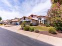 Charming home featuring a three car garage, beautiful landscaping, and desert plants in the front yard at 6154 E Karen Dr, Scottsdale, AZ 85254