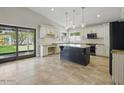 Open-concept kitchen with a large island, granite countertops, stainless steel appliances, and backyard access at 6154 E Karen Dr, Scottsdale, AZ 85254