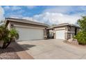 A large driveway and three car garage offer ample parking and storage space at 6204 W Hedgehog Pl, Phoenix, AZ 85083