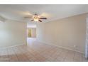 Spacious living room featuring tiled flooring, a ceiling fan, and neutral wall colors at 7038 W Fillmore St, Phoenix, AZ 85043