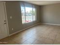 Bright living room with natural light, neutral walls, and tile flooring, awaiting personalization at 7136 W Cheryl Dr, Peoria, AZ 85345