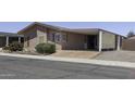 Charming single-story home with a covered carport, driveway, and desert landscaping at 880 W Moon Shadow Dr, Casa Grande, AZ 85122