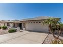 Well-maintained home with a two-car garage, complemented by desert landscaping and a quaint front porch at 11529 E Lindner Ave, Mesa, AZ 85209