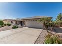 Well-maintained home with a two-car garage, complemented by desert landscaping and a quaint front porch at 11529 E Lindner Ave, Mesa, AZ 85209
