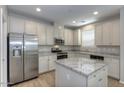Well-appointed kitchen with stainless steel appliances, granite countertops and a center island at 14870 W Encanto Blvd # 1106, Goodyear, AZ 85395