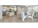 Open floor plan kitchen and dining area with stainless steel appliances and ample cabinet space at 14870 W Encanto Blvd # 1106, Goodyear, AZ 85395
