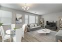 Bright living room featuring modern decor, neutral paint, stylish furniture, and natural light at 14870 W Encanto Blvd # 1106, Goodyear, AZ 85395