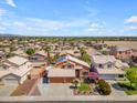Nice aerial view of a home with desert landscaping, a tiled roof, and a three-car garage at 16040 W Grant St, Goodyear, AZ 85338