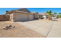 Well maintained driveway to attached 2 car garage, desert landscaping and tile roof in this property at 16817 W Bradford Way, Surprise, AZ 85374