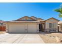 Inviting single-story home with a well-maintained desert-style yard and a convenient two-car garage at 16817 W Bradford Way, Surprise, AZ 85374
