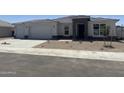 Charming single-story home with desert landscaping, a two-car garage, and stone elevation accents at 17747 W Brown St, Waddell, AZ 85355