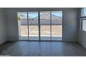 Living room with tile floors leading to large sliding glass doors and backyard views at 17747 W Brown St, Waddell, AZ 85355