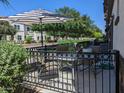 Cozy back patio features comfortable seating and a striped umbrella, creating a relaxing outdoor space at 1814 E Bridgeport Pkwy # 103, Gilbert, AZ 85295