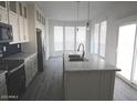 Bright kitchen with a large island, stainless steel appliances, and plenty of natural light at 1820 N Thornton Rd # 917, Casa Grande, AZ 85122
