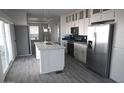 Modern kitchen with stainless steel appliances, white cabinets, and a large island for meal preparation at 1820 N Thornton Rd # 917, Casa Grande, AZ 85122