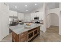 Bright kitchen with stainless steel appliances, a large island, and ample cabinet space at 19443 N 36Th St, Phoenix, AZ 85050