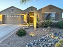 Charming home with a desert landscaped front yard featuring rocks and native plants at 2 W Pasture Canyon Dr, San Tan Valley, AZ 85143