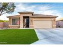 Inviting single-story home with a well-kept lawn, stone details, and a convenient two-car garage at 2024 E Cherry Hills Pl, Chandler, AZ 85249